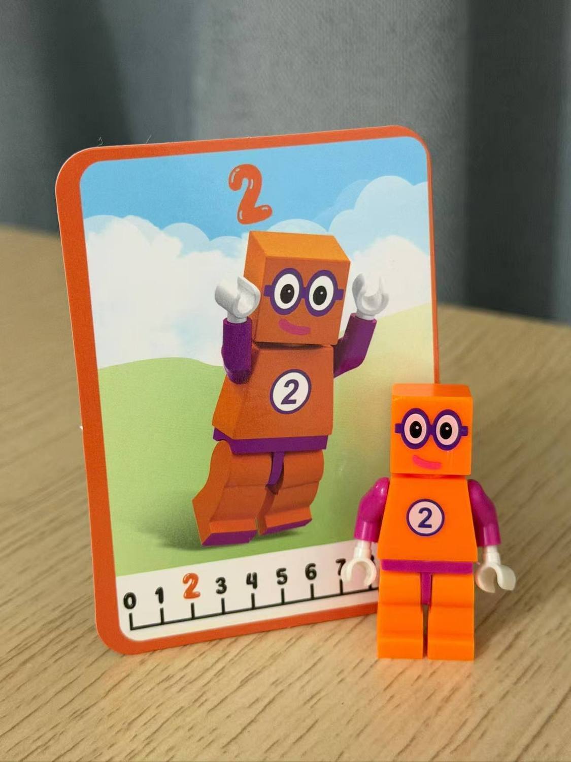Numberblocks building blocks toy set featuring orange figure and number card 2 for educational fun.